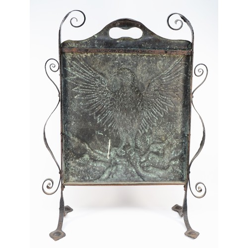 445 - An Arts and Crafts hand beaten copper fire screen, c. 1910/20, depicting an eagle with outstretched ... 