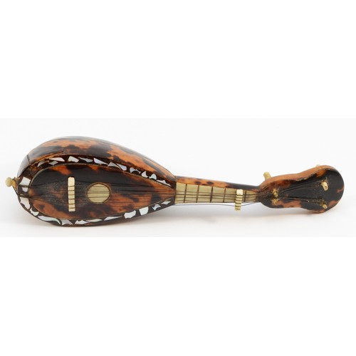 456 - A 19th century miniature tortoiseshell mandolin, with mother of pearl detail, 13.5cm