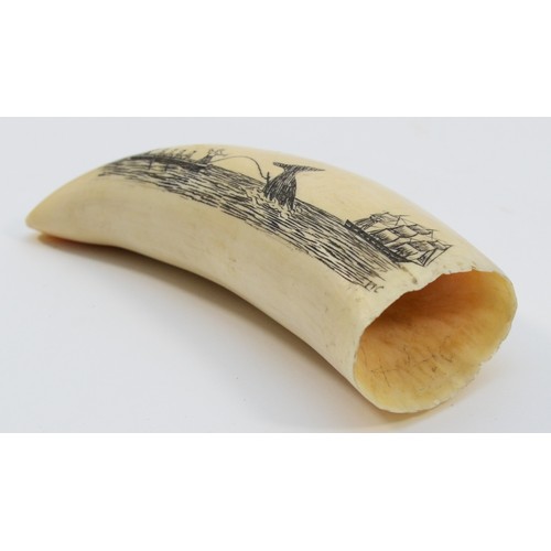 452 - A late 19th/early 20th century scrimshaw whale's tooth, incised with a three mask whaler and a rowin... 