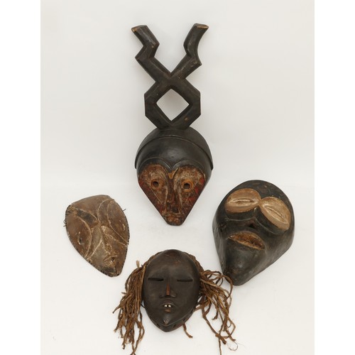 458 - Ethnographica & Tribal Art: A group of four African, Dan, Ivory Coast, tribal masks, carved wood wit... 