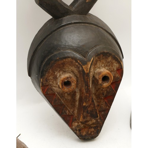 458 - Ethnographica & Tribal Art: A group of four African, Dan, Ivory Coast, tribal masks, carved wood wit... 