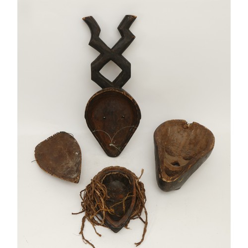 458 - Ethnographica & Tribal Art: A group of four African, Dan, Ivory Coast, tribal masks, carved wood wit... 