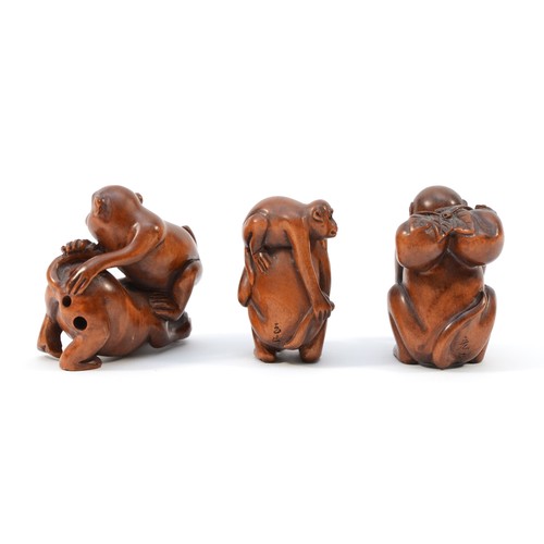 484 - A Japanese hardwood netsuke of a monkey with two young, signed and two other similar (3).