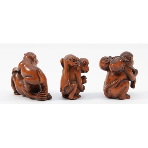 484 - A Japanese hardwood netsuke of a monkey with two young, signed and two other similar (3).