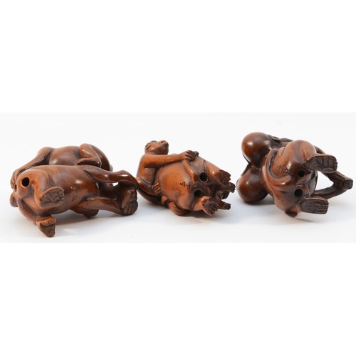 484 - A Japanese hardwood netsuke of a monkey with two young, signed and two other similar (3).