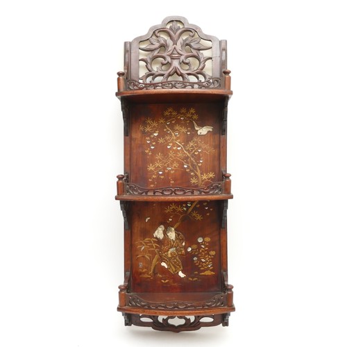 487 - A 20th century Chinese three height wall shelf, the carved galleried top above three curved shelves,... 