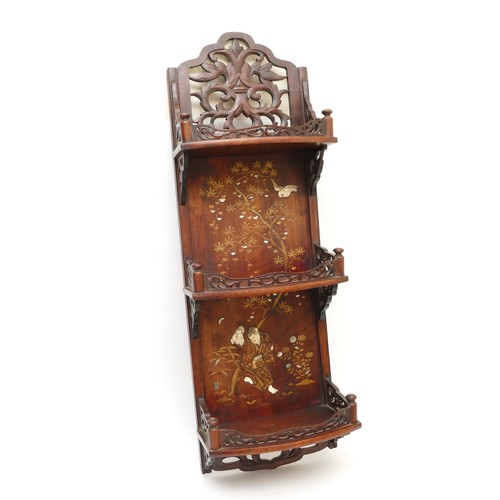 487 - A 20th century Chinese three height wall shelf, the carved galleried top above three curved shelves,... 