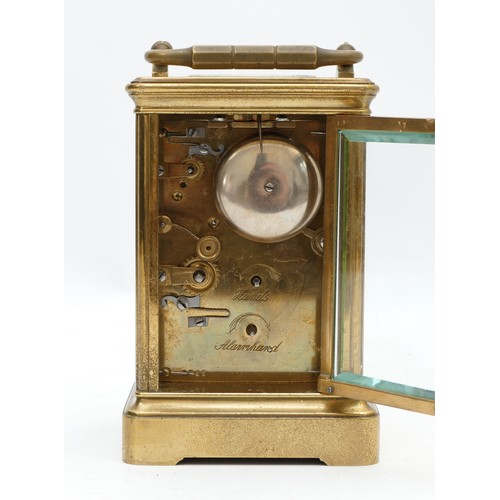 515 - An early 20th century brass alarm carriage time piece, white enamel dial with Roman numerals, the mo... 