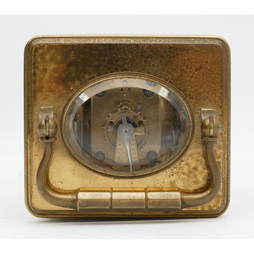 515 - An early 20th century brass alarm carriage time piece, white enamel dial with Roman numerals, the mo... 