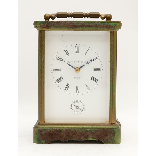 516 - Matthew Norman, London, an early 20th century brass alarm and striking carriage clock, the white ena... 