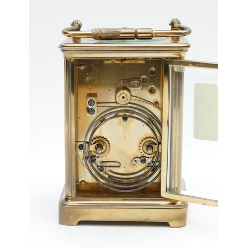 523 - A late 19th century brass striking carriage clock, white enamel dial with Roman numerals, the moveme... 