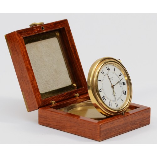 531 - Asprey, a gilt brass circular travel alarm clock with date aperture, synthetic sapphire crown, hours... 