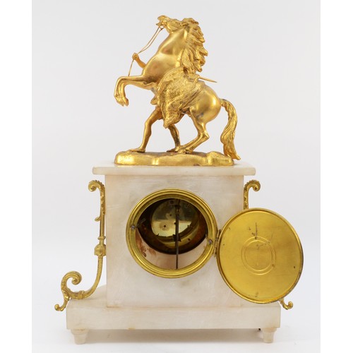 549 - A late 19th century French gilt metal and alabaster mantle clock, surmounted by a Marley horse, the ... 