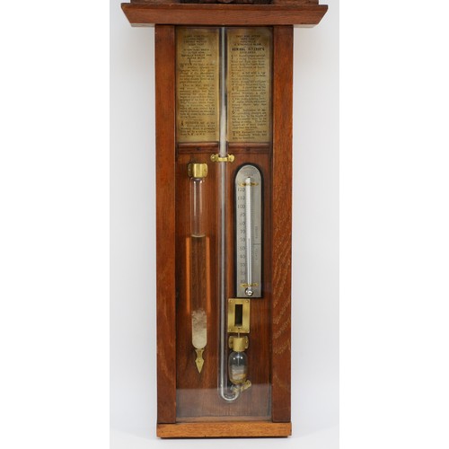 557 - A late 19th century Improved Admiral Fitzroy barometer in carved oak cased with printed circular sca... 