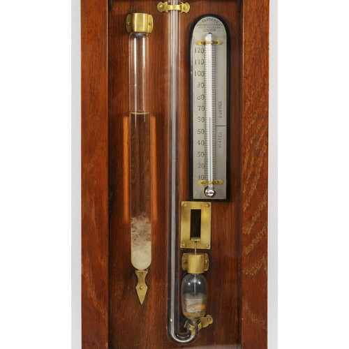 557 - A late 19th century Improved Admiral Fitzroy barometer in carved oak cased with printed circular sca... 