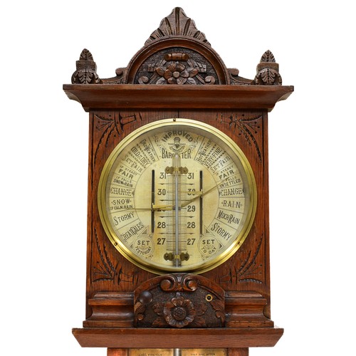 557 - A late 19th century Improved Admiral Fitzroy barometer in carved oak cased with printed circular sca... 