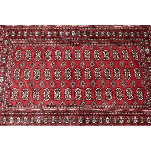 573 - A Teke Turkmen Bokhara Deluxe rug, with a fringe trim, the Teke design is inspired by elephant footp... 