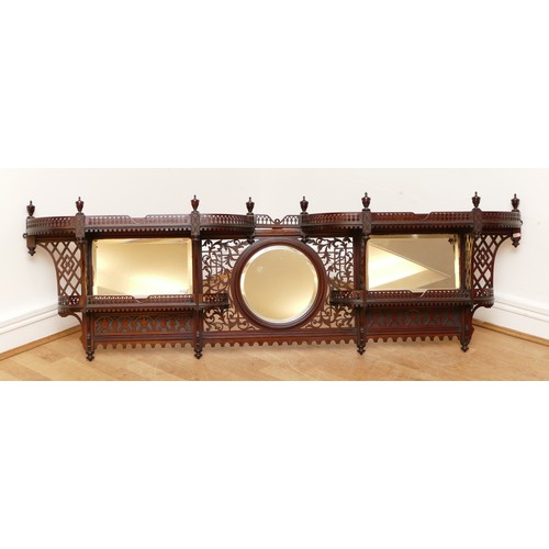 581 - An Edwardian mahogany wall-mounted over mantle display shelf, having central circular mirror, flanke... 