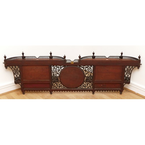 581 - An Edwardian mahogany wall-mounted over mantle display shelf, having central circular mirror, flanke... 