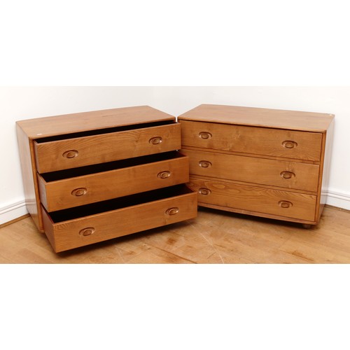 583 - A pair of 1960s Ercol 'Windsor' low chest of drawers, model 412 in light elm, having three long draw... 