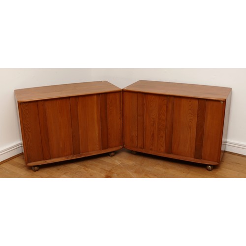 583 - A pair of 1960s Ercol 'Windsor' low chest of drawers, model 412 in light elm, having three long draw... 