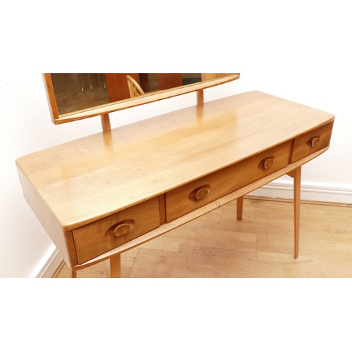 584 - A 1960s Ercol 'Windsor' light elm dressing table and chair, the rounded rectangular top mounted by r... 