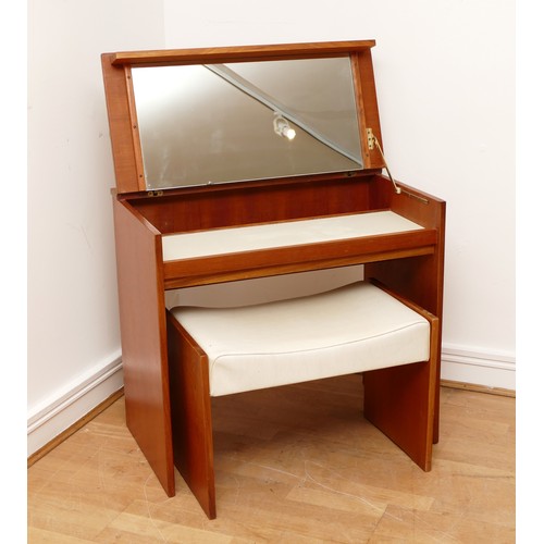 585 - A 1960s teak dressing/vanity table, the hinged top of rectangular form opening to mirrored interior,... 