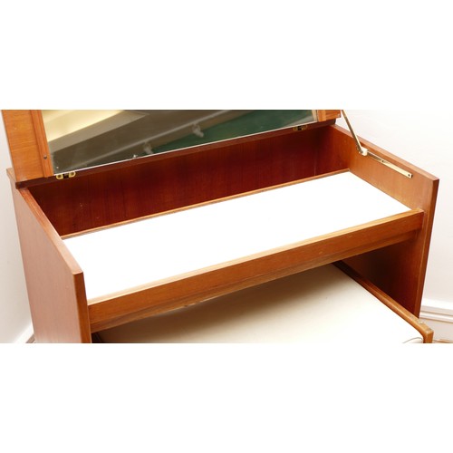 585 - A 1960s teak dressing/vanity table, the hinged top of rectangular form opening to mirrored interior,... 