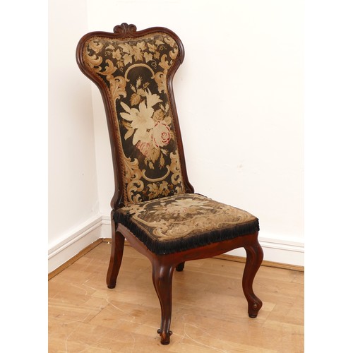 586 - A Victorian carved rosewood prieux deux chair, floral scroll back on cabriole legs, upholstered in f... 