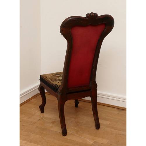 586 - A Victorian carved rosewood prieux deux chair, floral scroll back on cabriole legs, upholstered in f... 