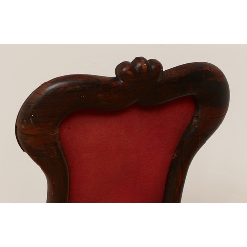 586 - A Victorian carved rosewood prieux deux chair, floral scroll back on cabriole legs, upholstered in f... 