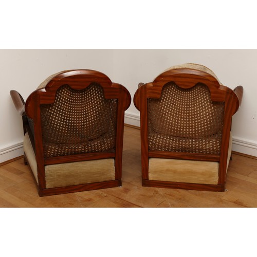 587 - A pair of Edwardian bergere armchairs, carved walnut frames with cane back and sides, floral upholst... 