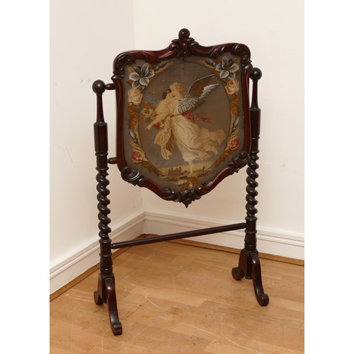 589 - A Victorian mahogany fire screen, scrolled foliage carved pediment, shield frame enclosing figural n... 