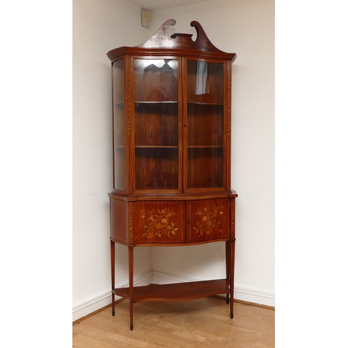 591 - An Edwardian inlaid fiddleback mahogany, satinwood and marquetry serpentine display cabinet, the swa... 