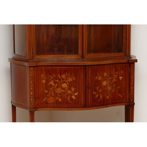 591 - An Edwardian inlaid fiddleback mahogany, satinwood and marquetry serpentine display cabinet, the swa... 