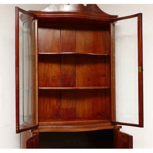 591 - An Edwardian inlaid fiddleback mahogany, satinwood and marquetry serpentine display cabinet, the swa... 