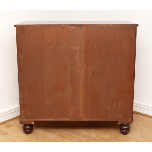 593 - A Victorian mahogany chest of two short and three long drawers with bun handles and turned columns, ... 