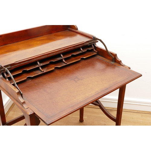 595 - A Victorian mahogany ladies writing desk, the hinged top of rectangular form opening to a slide out ... 