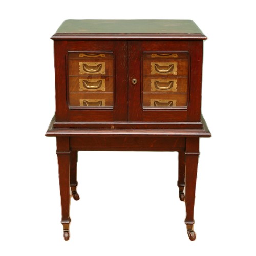 596 - A late 19th century oak canteen side cabinet, the two glazed doors opening to a bank of four drawers... 