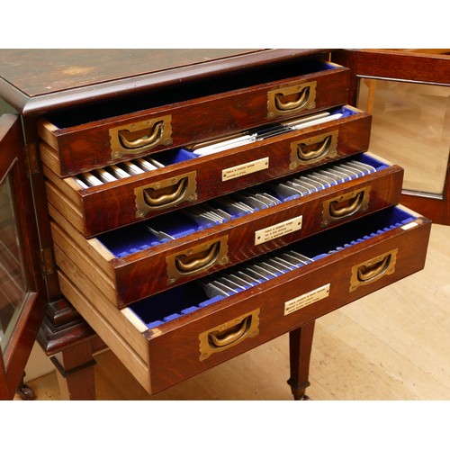 596 - A late 19th century oak canteen side cabinet, the two glazed doors opening to a bank of four drawers... 