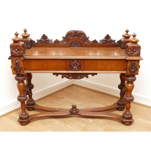 599 - An Edwardian carved oak entrance hall table, the rectangular top having galleried upstand carved fol... 