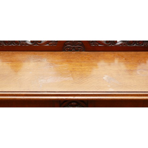 599 - An Edwardian carved oak entrance hall table, the rectangular top having galleried upstand carved fol... 