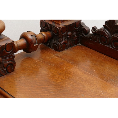 599 - An Edwardian carved oak entrance hall table, the rectangular top having galleried upstand carved fol... 