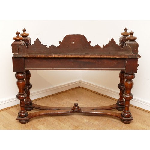 599 - An Edwardian carved oak entrance hall table, the rectangular top having galleried upstand carved fol... 