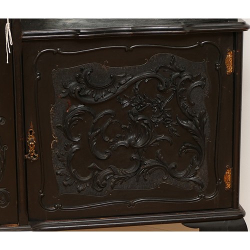 598 - An Edwardian ebonised Rococo style display cabinet, having moulded cornice above a glazed astragal d... 