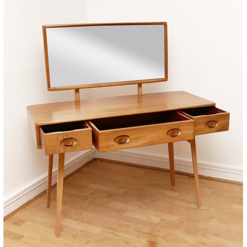 584 - A 1960s Ercol 'Windsor' light elm dressing table and chair, the rounded rectangular top mounted by r... 