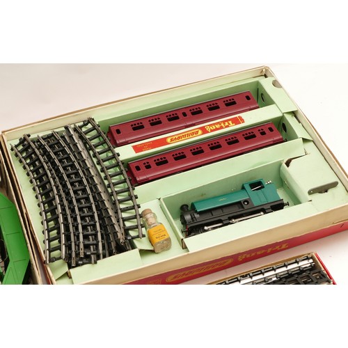 7 - A Tri-ang 00 gauge clockwork model train set, boxed, together with boxed and loose railway track and... 