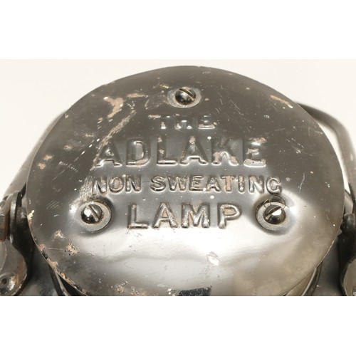 34 - An Adlake non-sweating lamp, marked 'Horsham', complete with burner.