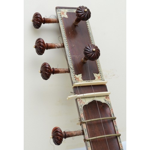 90 - An Indian Sitar, featuring five playing strings and eleven sympathetic strings and decorated with bo... 