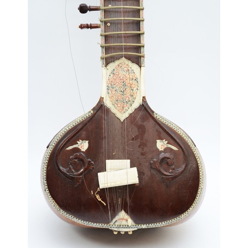 90 - An Indian Sitar, featuring five playing strings and eleven sympathetic strings and decorated with bo... 